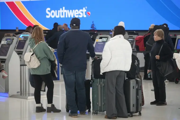 Travelers queue up at the check-in counters for Southwest Airlines in Denver International Airport