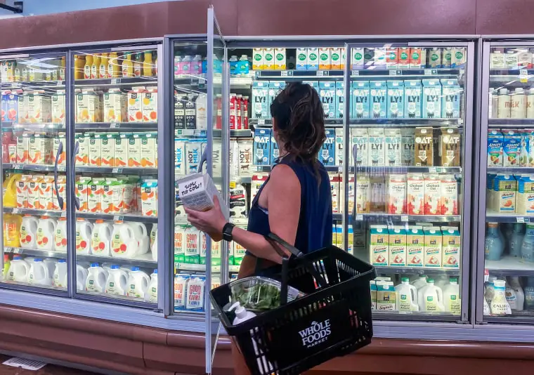 A woman shops for oat milk at a supermarket in Santa Monica, Calif., on Sept. 13, 2022. 