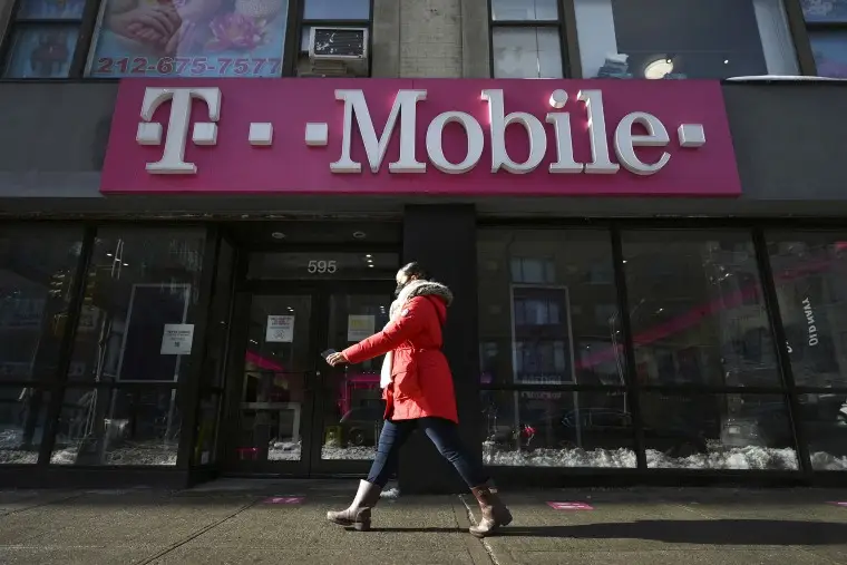 A womman walks past a T-Mobile retail store in New York, NY, January 31, 2022. It was reported that T-Mobile US Inc. is planning on terminating corporate employees who are not fully vaccinated against COVID-19 by April 2nd.