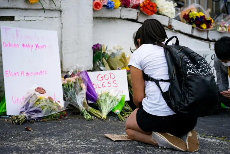 A person mourns at a memorial at Gold Spa in Atlanta