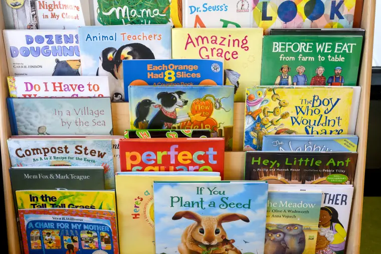 Books sit on a shelf at LaPetite Academy, an on-site child care center for airport and airline employees at Pittsburgh International Airport, on July 25, 2023 in Moon Township, Pa.