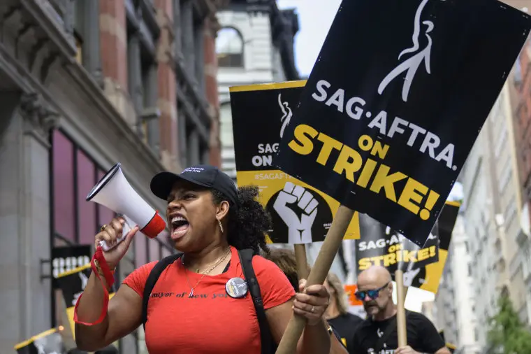 Members of the Writers Guild of America and the Screen Actors Guild walk a picket line outside of Netflix and Warner Bros. Discovery in New York City on Aug. 2, 2023. 