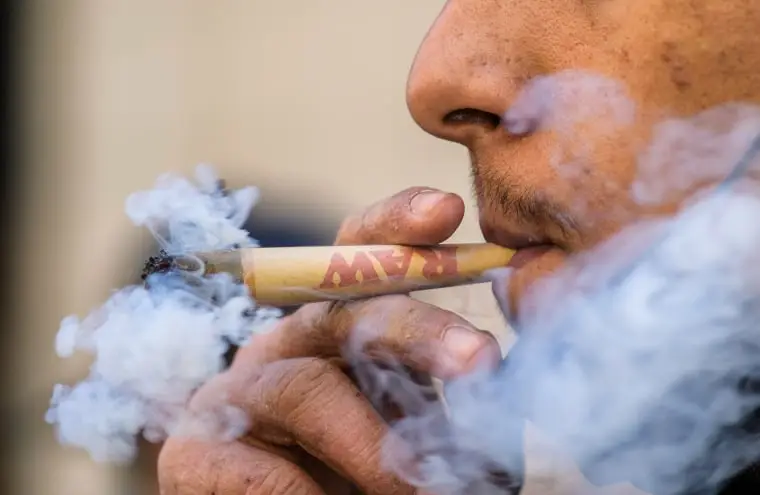 A person smokes marijuana in New York on May 1, 2021.