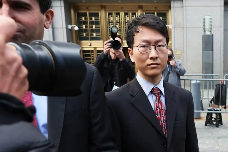 Gary Wang walks past photographers as exits the courthouse